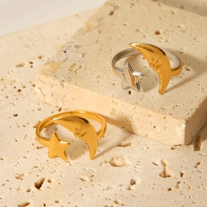 Adjustable 18K gold plated celestial star and moon open ring on a stone pedestal
