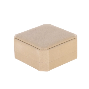 Macro shot of an octagonal beige velvet jewelry box showing soft texture and premium detail