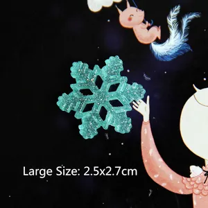 Detailed macro view of mint green resin snowflake with golden glitter, size 2.5x2.7cm