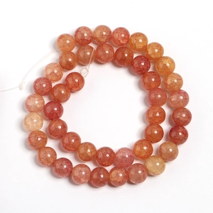 Macro detail of orange dragon-vein glass beads with cracked texture for DIY jewelry
