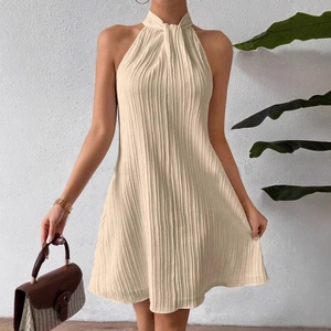 Elegant apricot pleated halter neck mini dress with a textured sleeveless finish