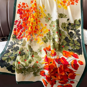 Floral print silk scarf in cream and orange with dark green borders and accessory styling
