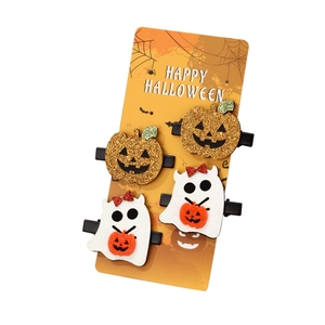 Set of 4 Halloween hair clips with glitter pumpkins and white ghosts on a festive orange card