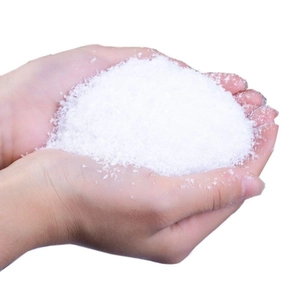 Artificial white snow powder for Christmas decor held in hands showing fluffy texture