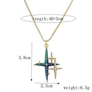 Detail of gold chain with planet pendant showing 3.8x2.5cm dimensions and enamel star design