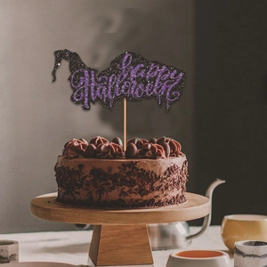 Detail of Happy Halloween cake topper with black and purple glitter and witch hat silhouette