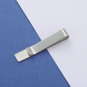 Macro shot of matte silver rectangle tie clip with high-quality brushed metal texture
