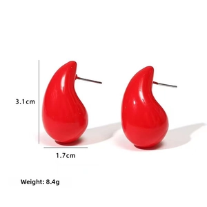 Detail view of red teardrop earrings showing 3.1cm height and 1.7cm width dimensions