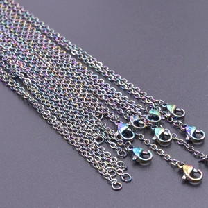 Detailed macro view of multi-colored rainbow stainless steel link chains with lobster clasps