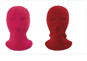 Detail view of pink and dark red knitted balaclavas with three-hole design for winter