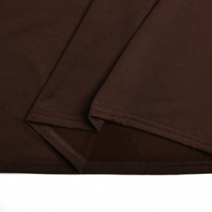 Detailed close-up showing fabric texture and neat hem stitching on a dark brown dress
