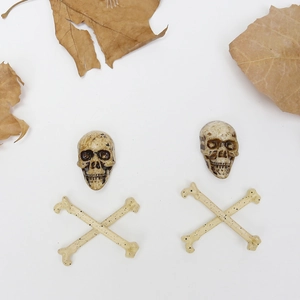 Detailed view of DIY Halloween skeleton skulls and crossbones with rustic bone texture