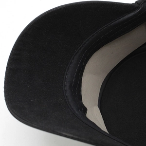 Detail view of the black fabric brim and reinforced inner sweatband of the warm flat cap