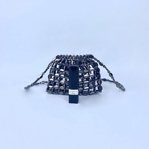 Detailed view of gunmetal beaded mini bag showing metallic texture and lipstick size scale
