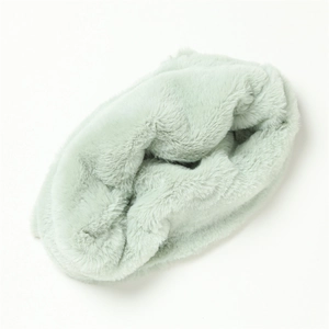 Macro detail of soft light green faux rabbit fur neck warmer with plush long hair texture