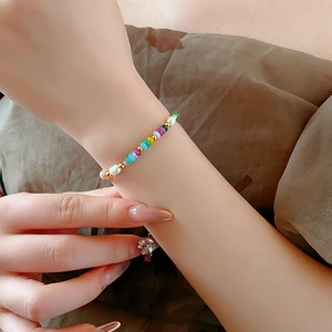Detail of 18K gold-plated bracelet with colorful beads and pearls on a model wrist