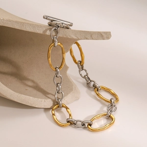 Detailed close-up of mixed gold and silver chunky chain with OT toggle clasp and metal rings