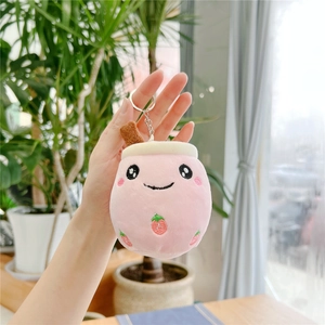 Close-up of pink bubble tea plush keychain with strawberry embroidery and a silver ring