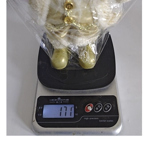 Standing Santa Claus doll weighing 171g on digital scale showing product weight detail