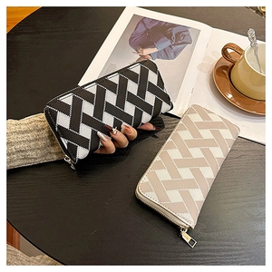 Detail of woven texture long wallets in beige and black with geometric cross patterns
