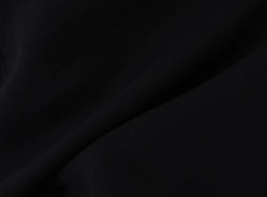 Detailed macro view of black twill fabric texture and durable stitching on strapless top