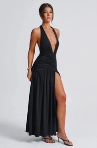 Detail of elegant black halter neck maxi dress with deep V-neckline and high side slit