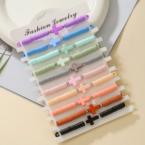 Detail of colorful polymer clay cross bracelet set on a white jewelry display card