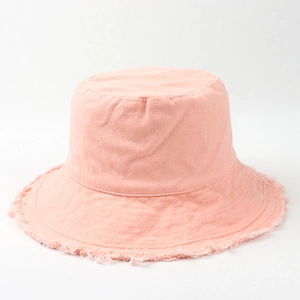 Detailed view of frayed edges on a light pink cotton canvas bucket hat for women