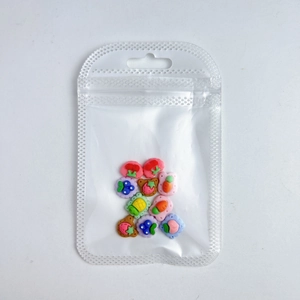 Colorful resin fruit cookie charms for DIY crafts in clear packaging bag macro view