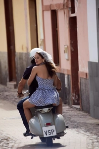 Blue plaid halter mini dress with backless tie-up bow detail on a vintage motorcycle