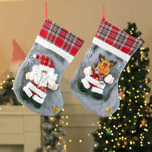 Large gray Christmas stockings with 3D Santa and Reindeer designs and red plaid cuffs