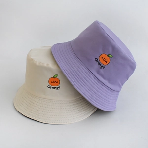 Detail of orange embroidery on white and purple reversible cotton bucket hats
