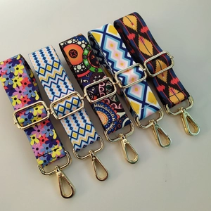 Detail of adjustable colorful woven shoulder straps with gold metal hooks and ethnic patterns