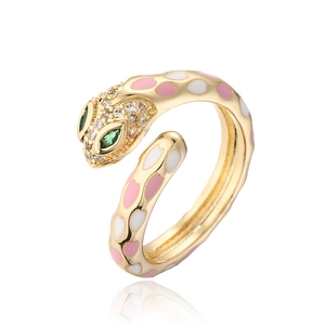 Macro shot of 18k gold plated snake ring with pink enamel dots and green crystal eyes
