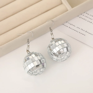 Silver disco ball mirror earrings on beige jewelry display tray for party gift