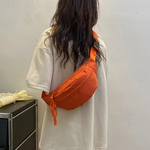Orange nylon crossbody sling bag with adjustable strap for women in casual outdoor travel