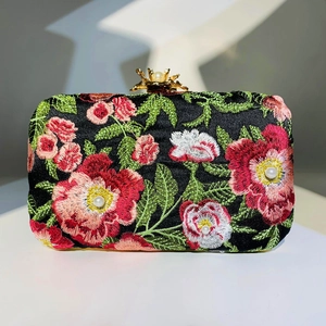 Elegant rectangular evening clutch with floral embroidery and pearl accents on black fabric