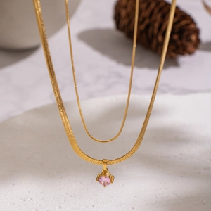 Double-layer gold snake chain necklace featuring a faceted pink zircon stone pendant