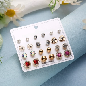 Detail shot of 12 pairs of floral heart and star stud earrings with colorful rhinestones