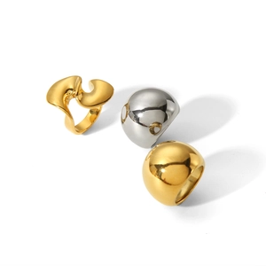 Macro shot of 18K gold and silver polished spiral geometric rings on white background