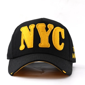 Close-up of black baseball cap featuring 3D yellow NYC felt letters and distressed brim