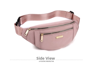 Detail view of pink nylon waist bag showing three golden zippers and adjustable strap