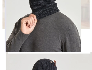 Detailed texture of charcoal grey ribbed knit beanie with wooden button and leather patch