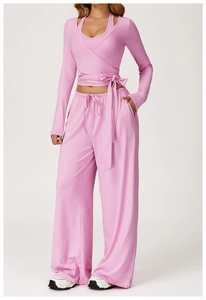 Detail of pink wrap yoga top with waist tie and high waist wide leg pants set