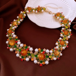 Detailaufnahme der Vintage-Blumenhalskette mit bunten Edelsteinen und Perlen auf Satin