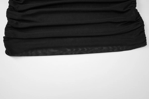 Detail of the black mesh dress showing pleated texture and breathable sheer fabric