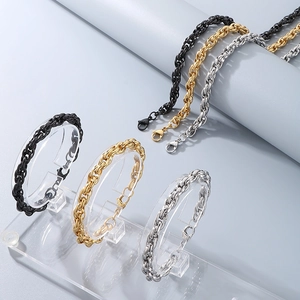 Detailed view of twisted curb chain bracelets in black, gold, and silver stainless steel