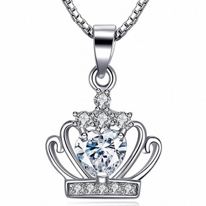 Detailed view of silver crown pendant featuring a heart-cut cubic zirconia on a box chain
