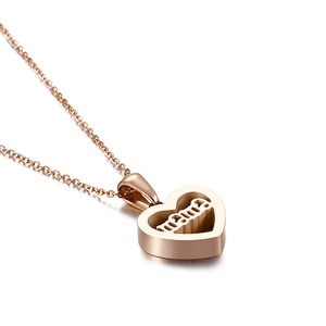 Rose gold heart pendant necklace featuring hollowed mama letter design on white background