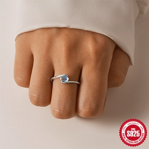 Elegant S925 sterling silver ring with oval blue gemstone on a woman's finger